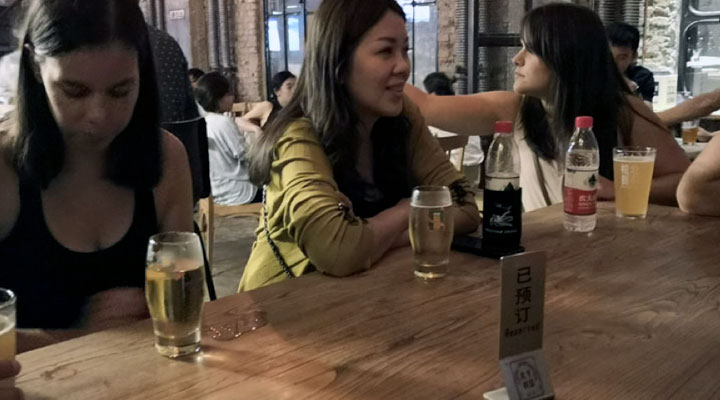 people enjoying craft beer in a local beijing brewery